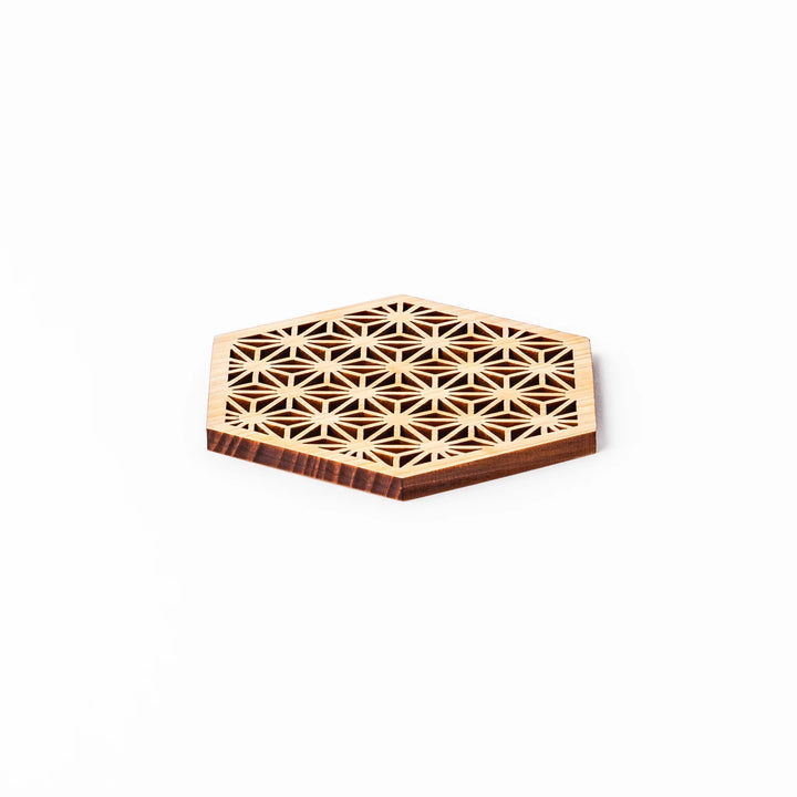 Hinoki wood coaster with a detailed hemp star cutout pattern in a hexagon shape against a white background.