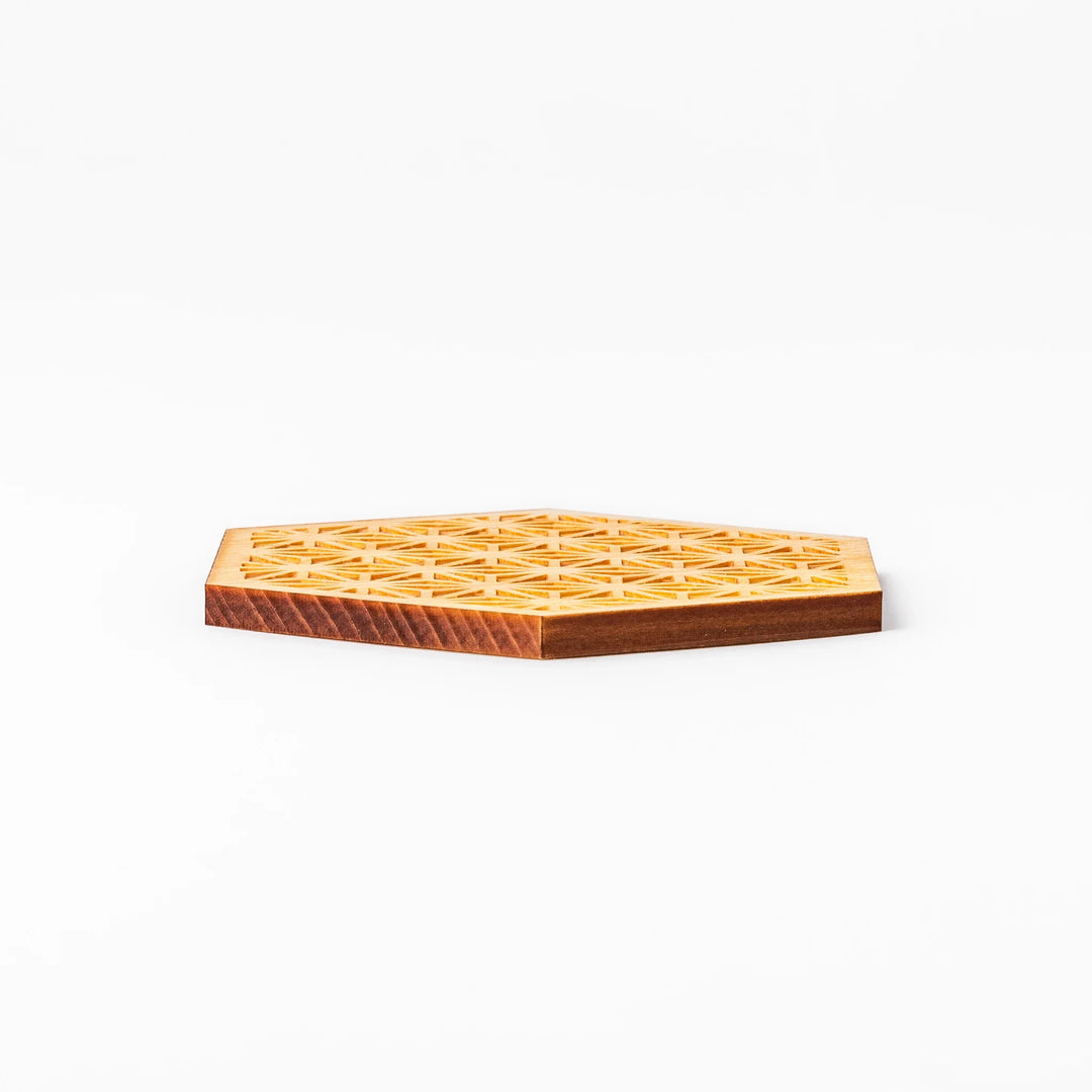 Hexagon hinoki wood coaster with engraved hemp star pattern on a white background.