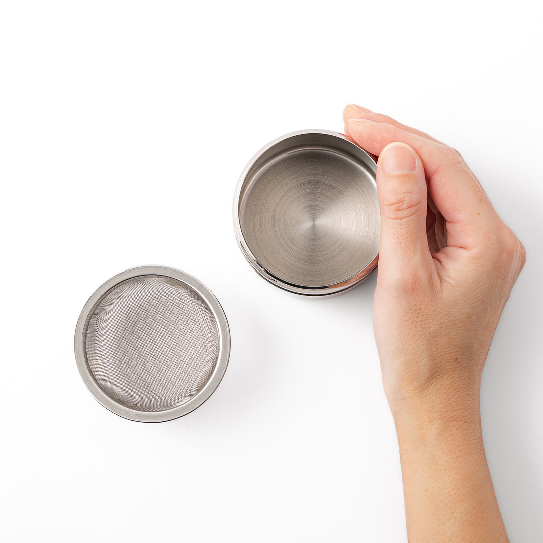 A Japanese stainless steel matcha sifter canister set with a fine mesh strainer scoop and sifting rings for smooth matcha powder