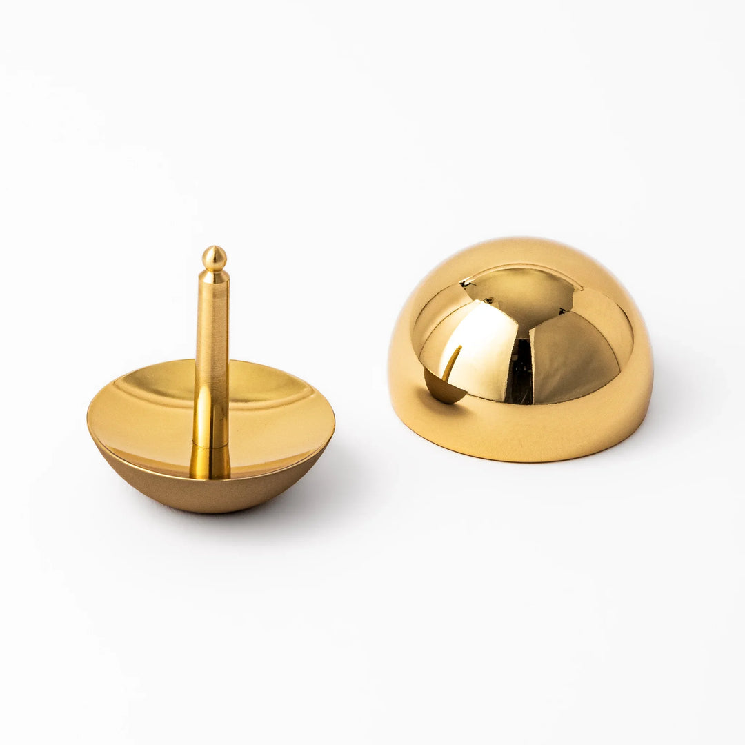 Japanese meditation and prayer chime with golden dome bell and wooden striker for mindfulness rituals.