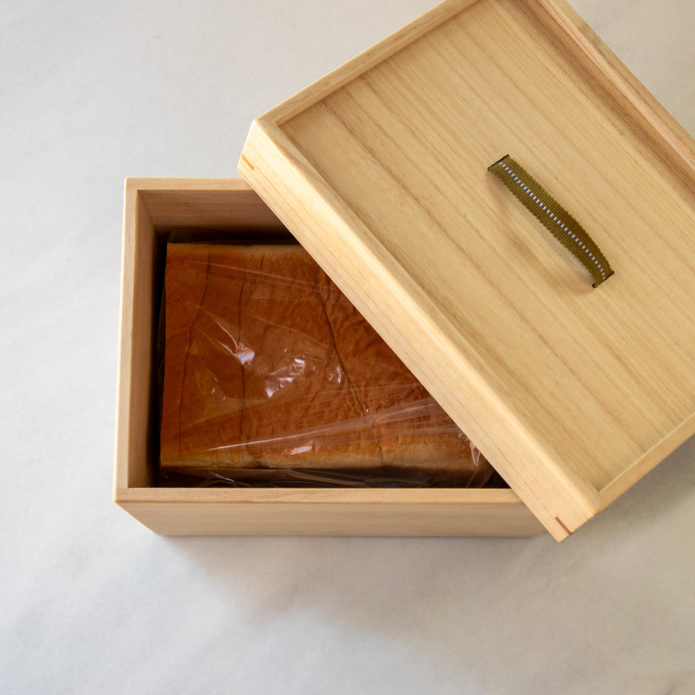 Japanese Paulownia Wood Bread Storage Box 1.5 Loaf size featuring Sanada cord handle and bread inside   