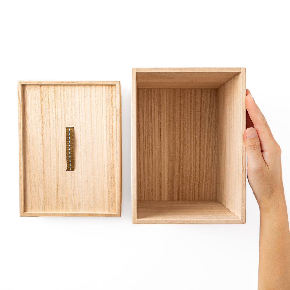 Nami from JOC holding an open Japanese Paulownia Wood Bread Storage Box 1.5 Loaf size with lid placed beside it