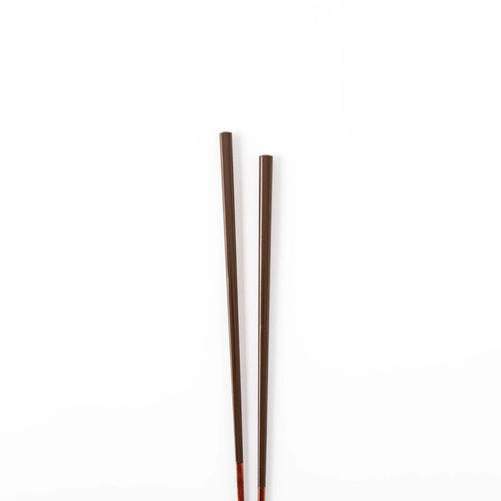 Pair of chestnut brown Japanese traditional color bamboo chopsticks with slim tips for refined and accurate dining