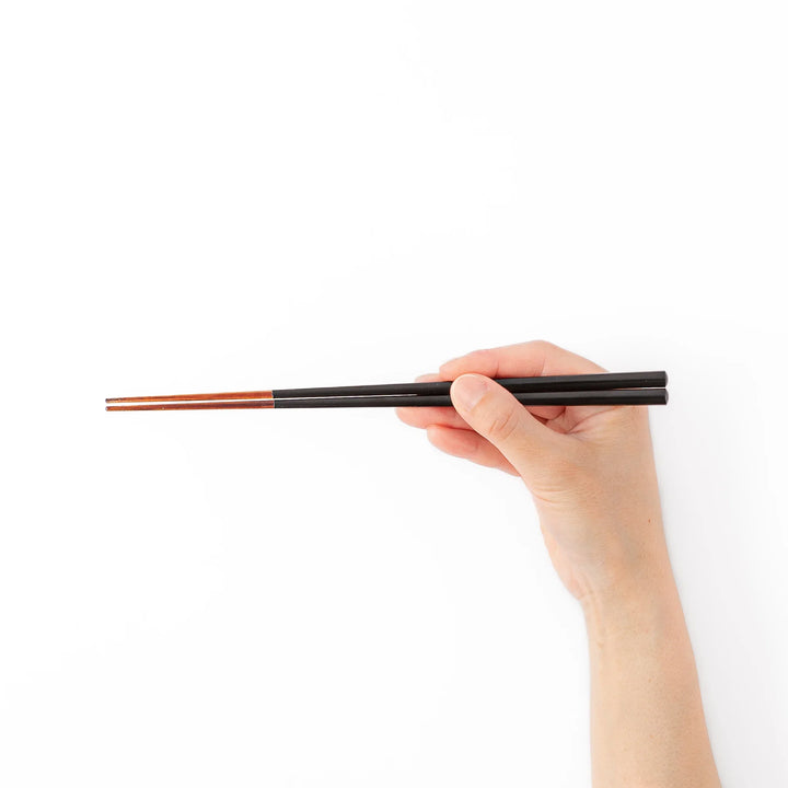 Pair of lacquer black Japanese traditional color bamboo chopsticks with fine tips for an elegant and precise dining experience