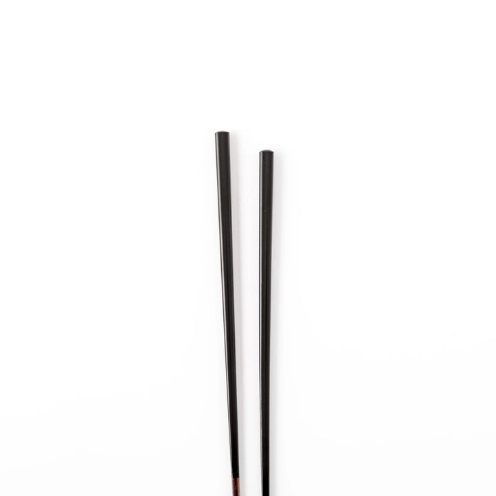 Pair of lacquer black Japanese traditional color bamboo chopsticks with fine tips for an elegant and precise dining experience