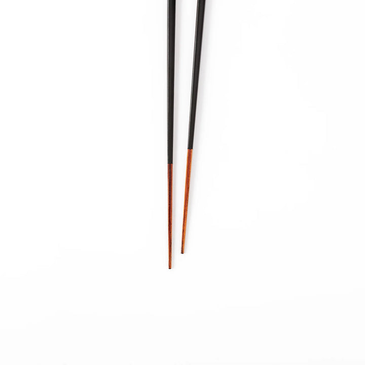 Pair of lacquer black Japanese traditional color bamboo chopsticks with fine tips for an elegant and precise dining experience