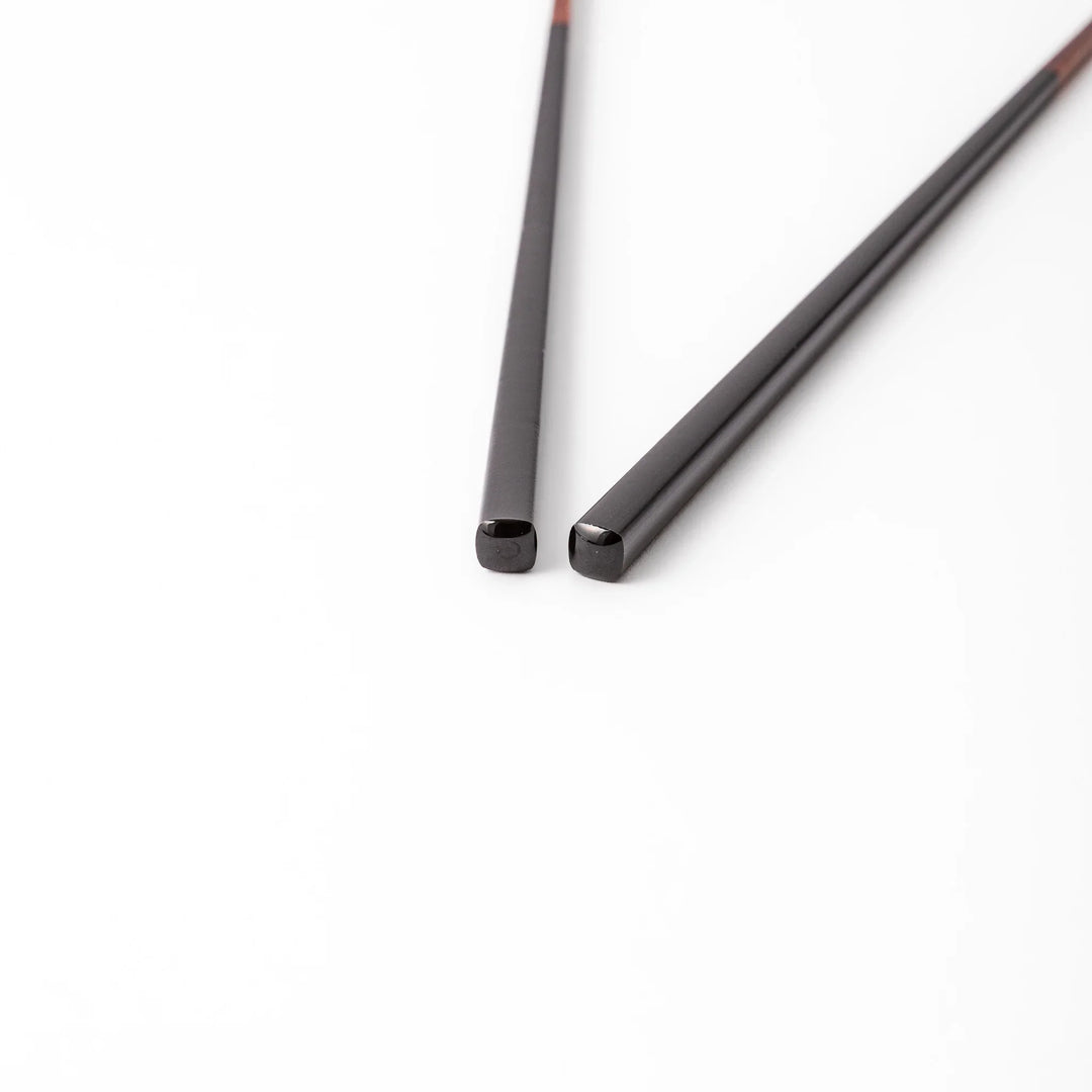 Pair of lacquer black Japanese traditional color bamboo chopsticks with fine tips for an elegant and precise dining experience