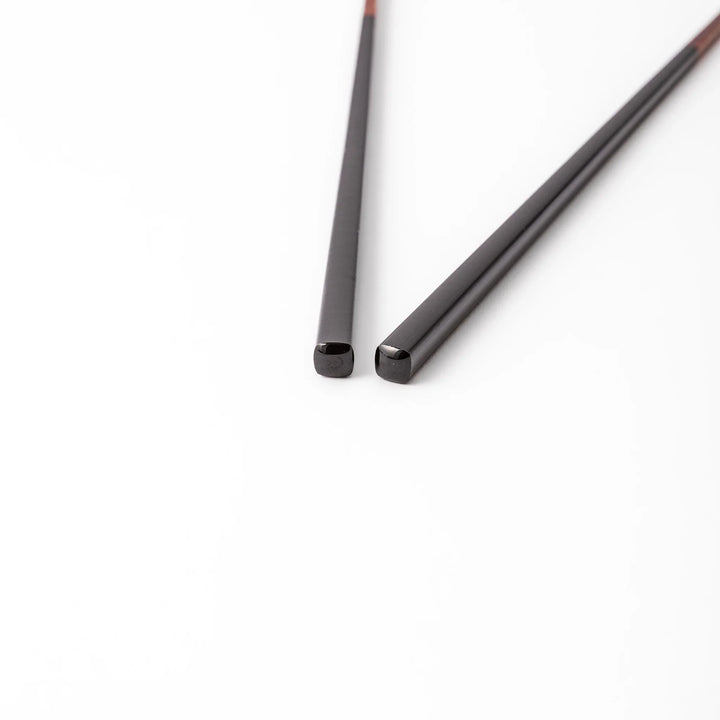 Pair of lacquer black Japanese traditional color bamboo chopsticks with fine tips for an elegant and precise dining experience