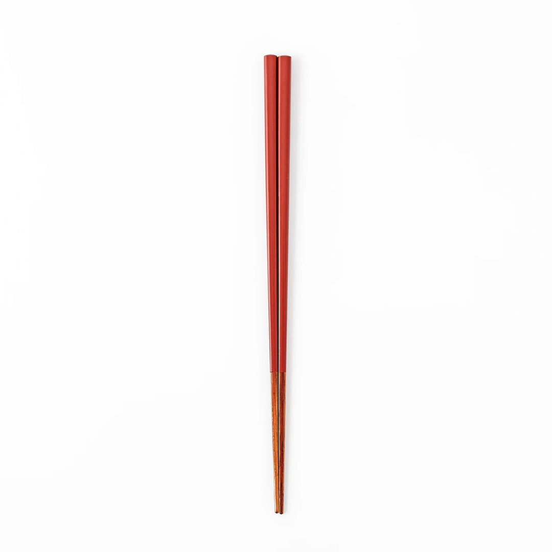 Pair of ancient vermillion red Japanese traditional color bamboo chopsticks with fine tips for an elegant dining experience
