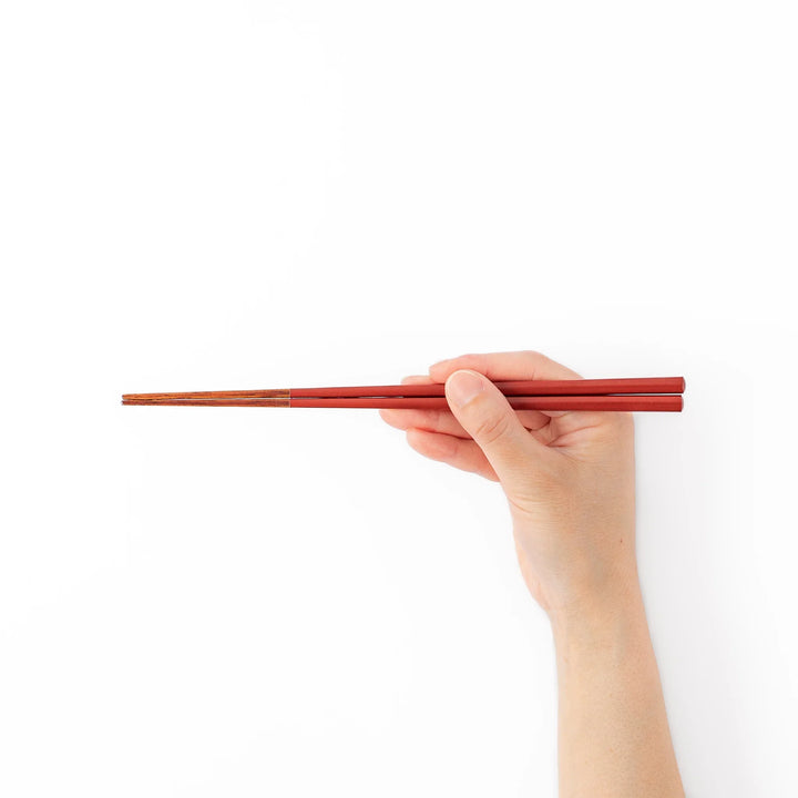 Pair of ancient vermillion red Japanese traditional color bamboo chopsticks with fine tips for an elegant dining experience