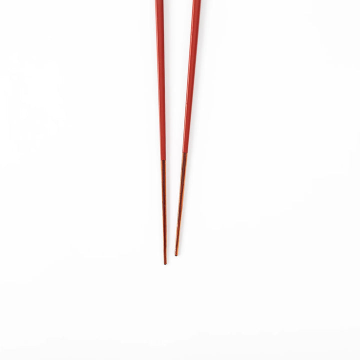 Pair of ancient vermillion red Japanese traditional color bamboo chopsticks with fine tips for an elegant dining experience