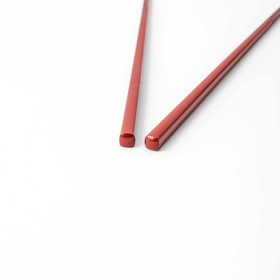 Pair of ancient vermillion red Japanese traditional color bamboo chopsticks with fine tips for an elegant dining experience