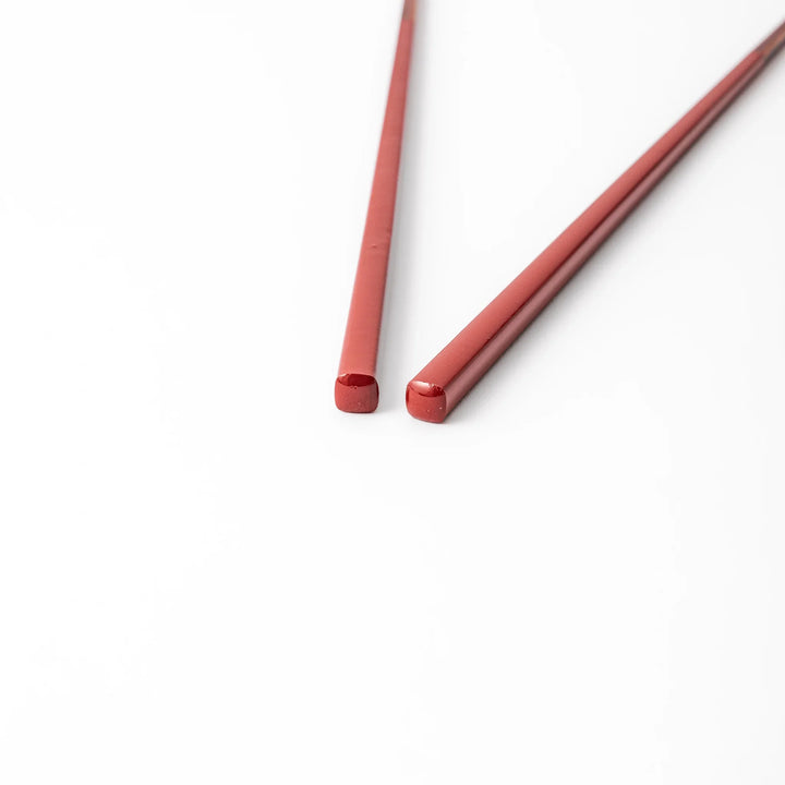 Pair of ancient vermillion red Japanese traditional color bamboo chopsticks with fine tips for an elegant dining experience
