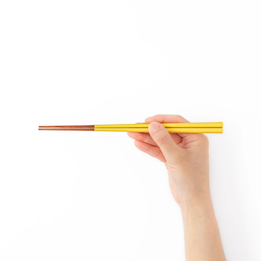 Pair of golden yellow Japanese traditional color bamboo chopsticks with fine tips for an elegant and precise dining experience
