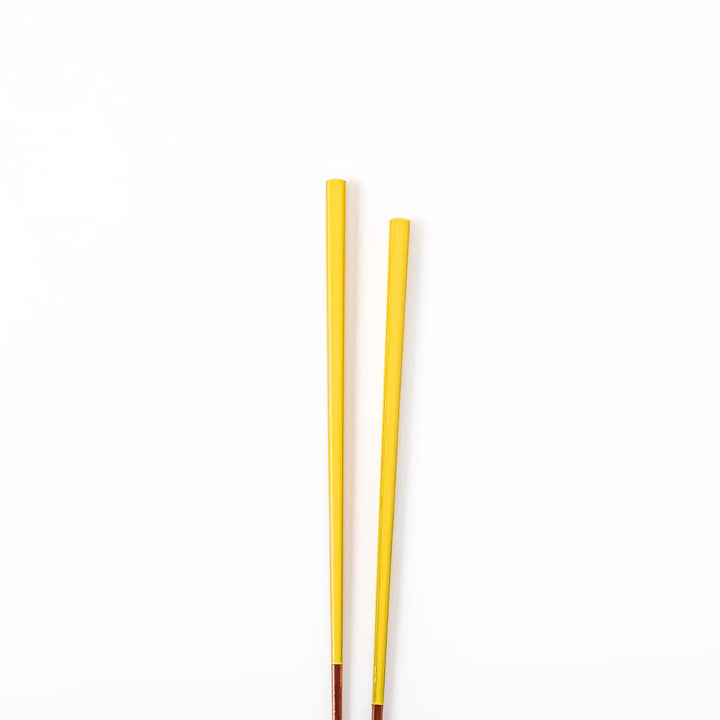 Pair of golden yellow Japanese traditional color bamboo chopsticks with fine tips for an elegant and precise dining experience