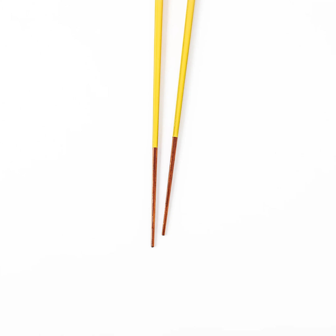 Pair of golden yellow Japanese traditional color bamboo chopsticks with fine tips for an elegant and precise dining experience