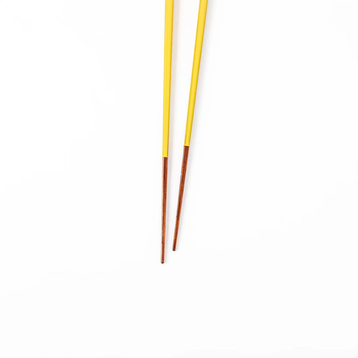 Pair of golden yellow Japanese traditional color bamboo chopsticks with fine tips for an elegant and precise dining experience