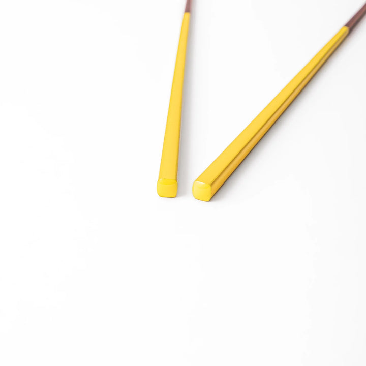Pair of golden yellow Japanese traditional color bamboo chopsticks with fine tips for an elegant and precise dining experience