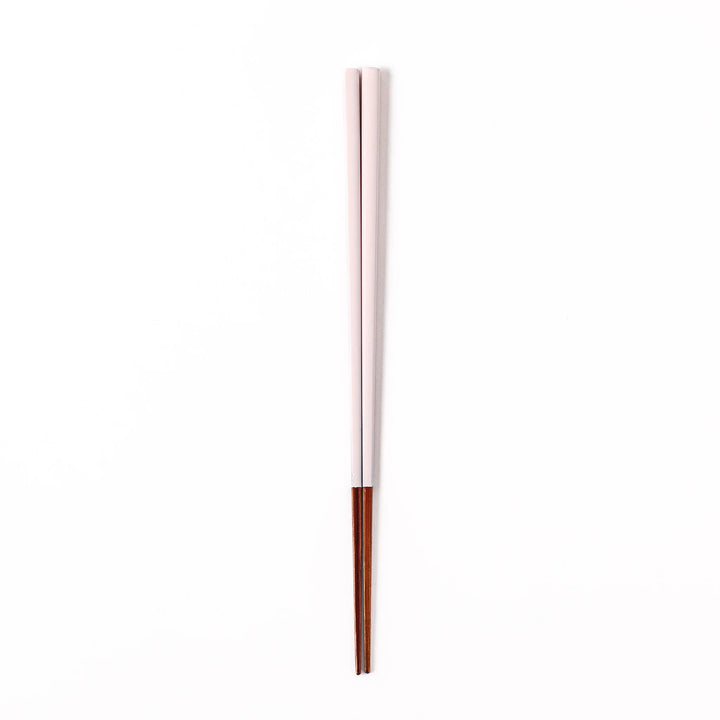 Pair of pale sakura pink Japanese traditional color bamboo chopsticks with fine tips for an elegant and precise dining experience