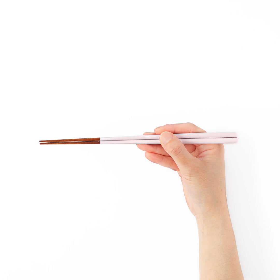 Pair of pale sakura pink Japanese traditional color bamboo chopsticks with fine tips for an elegant and precise dining experience
