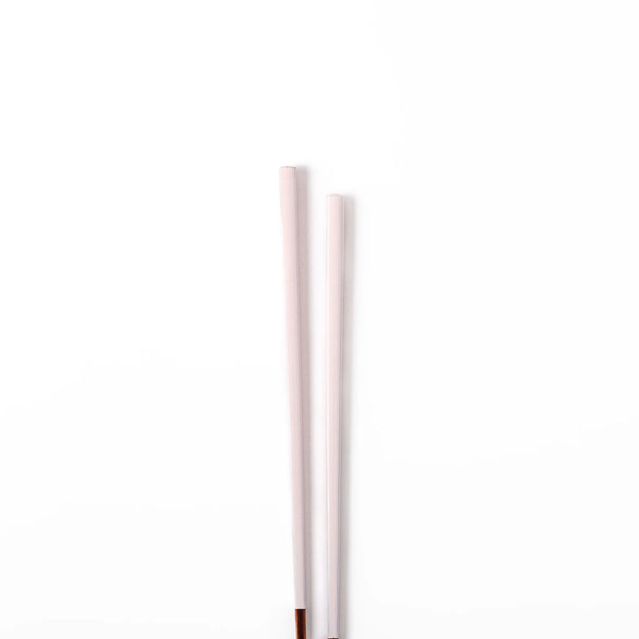 Pair of pale sakura pink Japanese traditional color bamboo chopsticks with fine tips for an elegant and precise dining experience