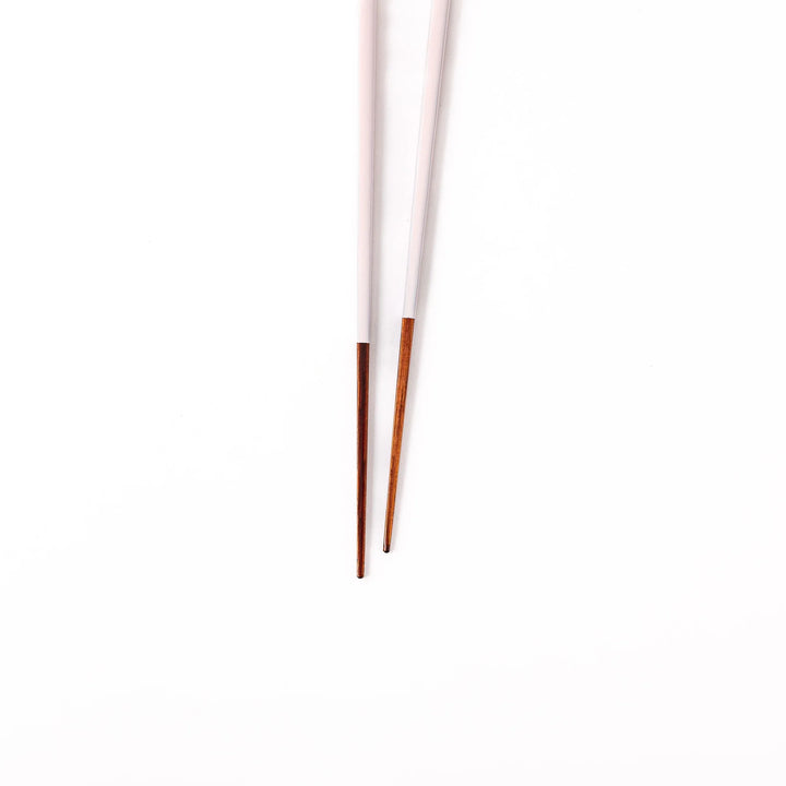 Pair of pale sakura pink Japanese traditional color bamboo chopsticks with fine tips for an elegant and precise dining experience