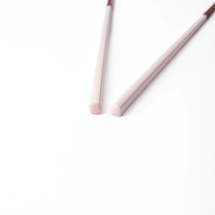 Pair of pale sakura pink Japanese traditional color bamboo chopsticks with fine tips for an elegant and precise dining experience