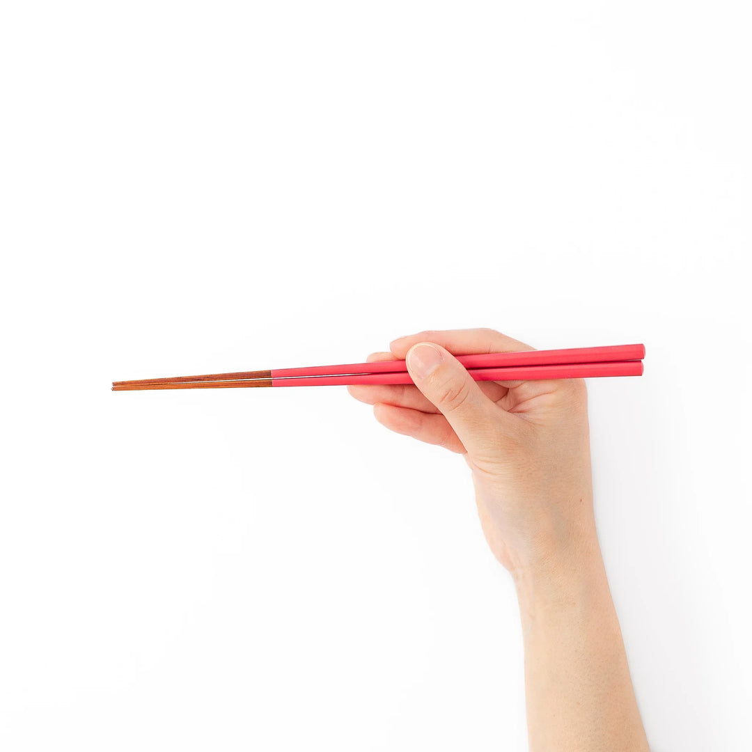 Pair of deep crimson Japanese traditional color bamboo chopsticks with fine tips for an elegant and precise dining experience