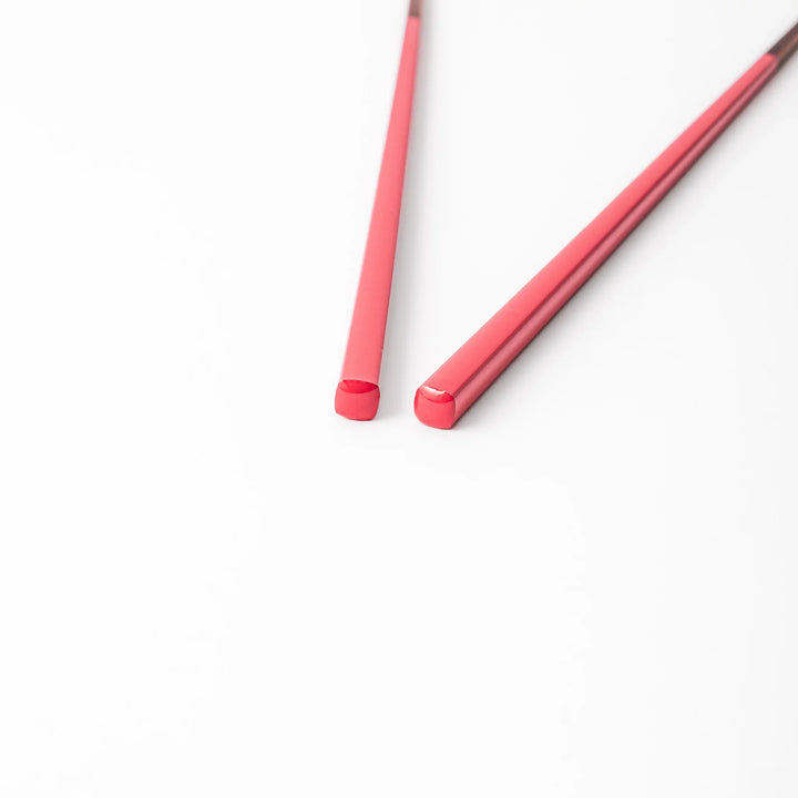 Pair of deep crimson Japanese traditional color bamboo chopsticks with fine tips for an elegant and precise dining experience
