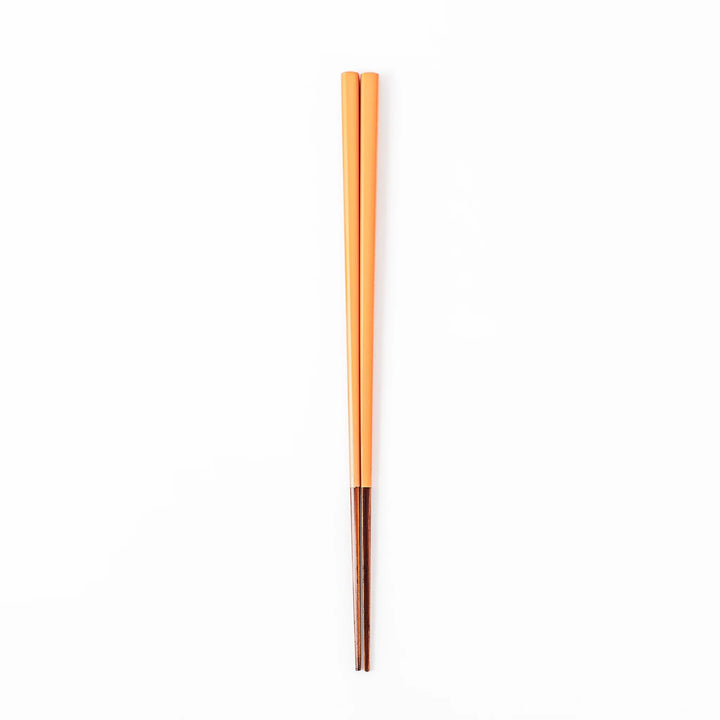 Pair of persimmon orange Japanese traditional color bamboo chopsticks with fine tips for precise and elegant dining