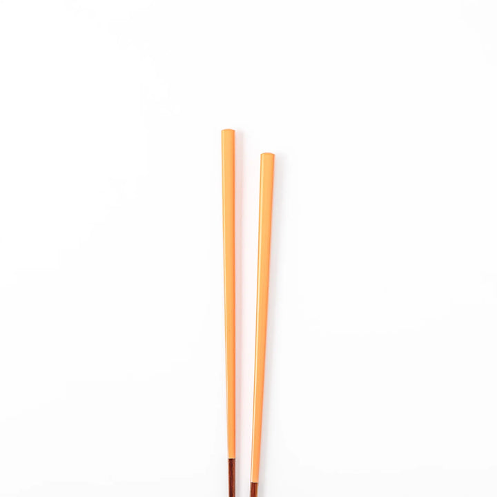 Pair of persimmon orange Japanese traditional color bamboo chopsticks with fine tips for precise and elegant dining