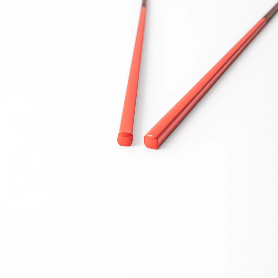 Pair of safflower red Japanese traditional color bamboo chopsticks with fine tips for an elegant and precise dining experience