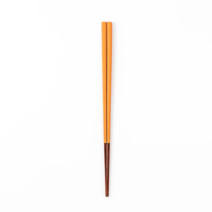 Pair of tangerine orange Japanese traditional color bamboo chopsticks with fine tips for a precise and elegant dining experience