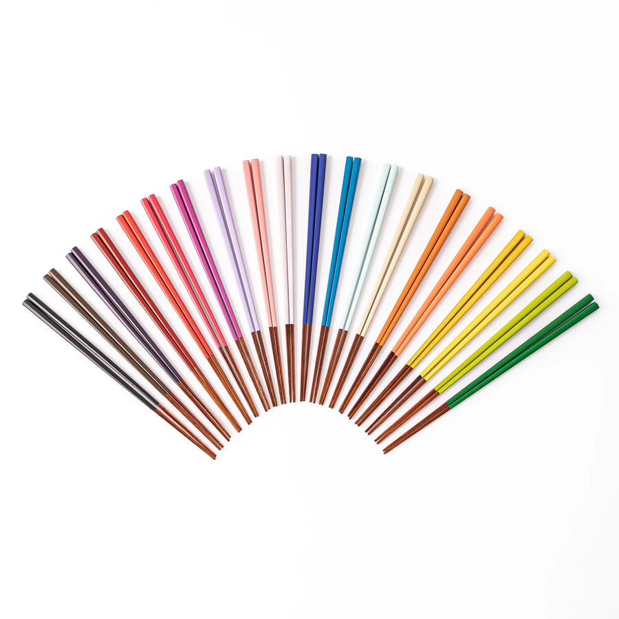 Variety of Japanese traditional color bamboo chopsticks arranged in a colorful fan shape on a clean white background