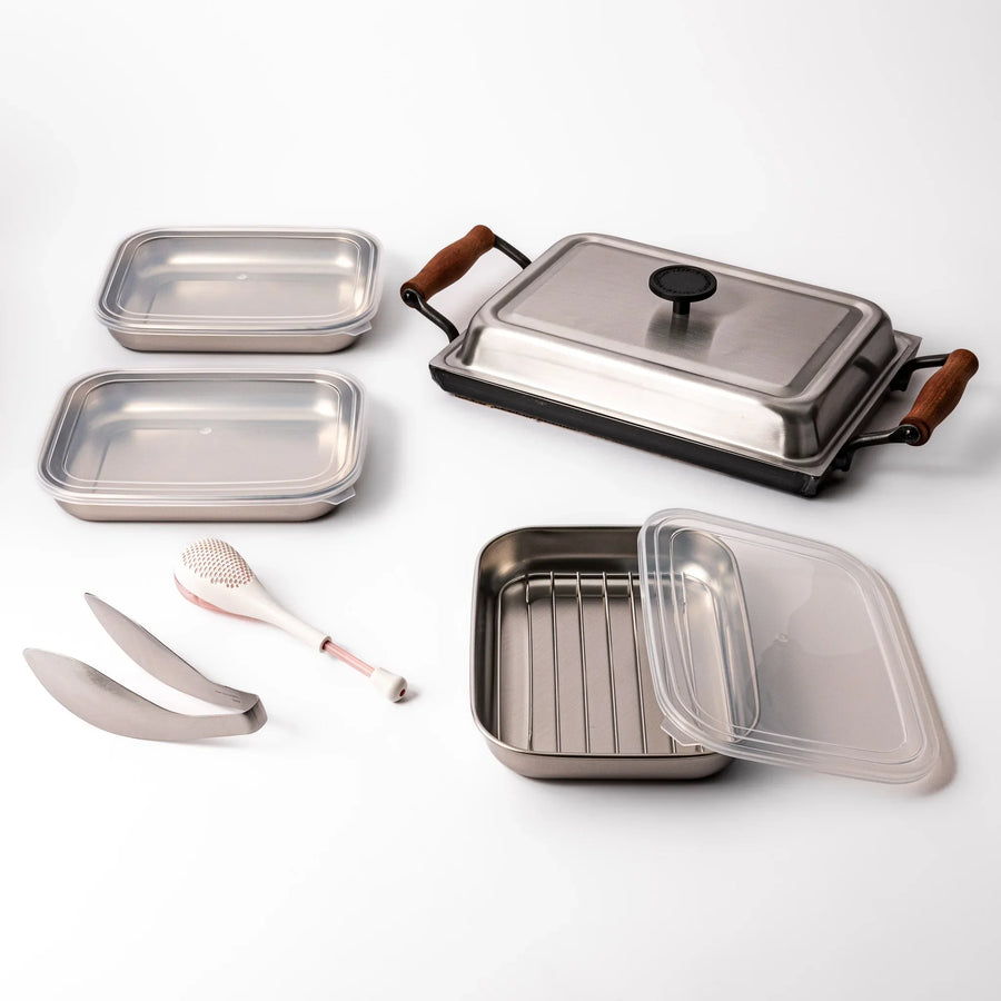Japanese grill and marinate set with stovetop grill trays rack rice paddle and tongs for home grilling.