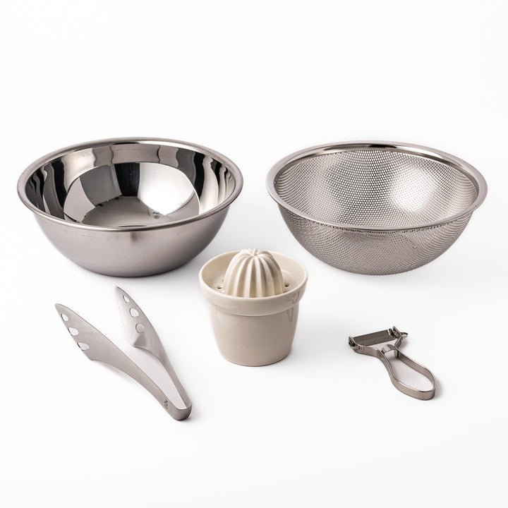 Japanese salad prep set featuring stainless steel mixing and strainer bowls, ceramic citrus juicer, peeler, and tongs, designed for effortless vegetable and dressing preparation.