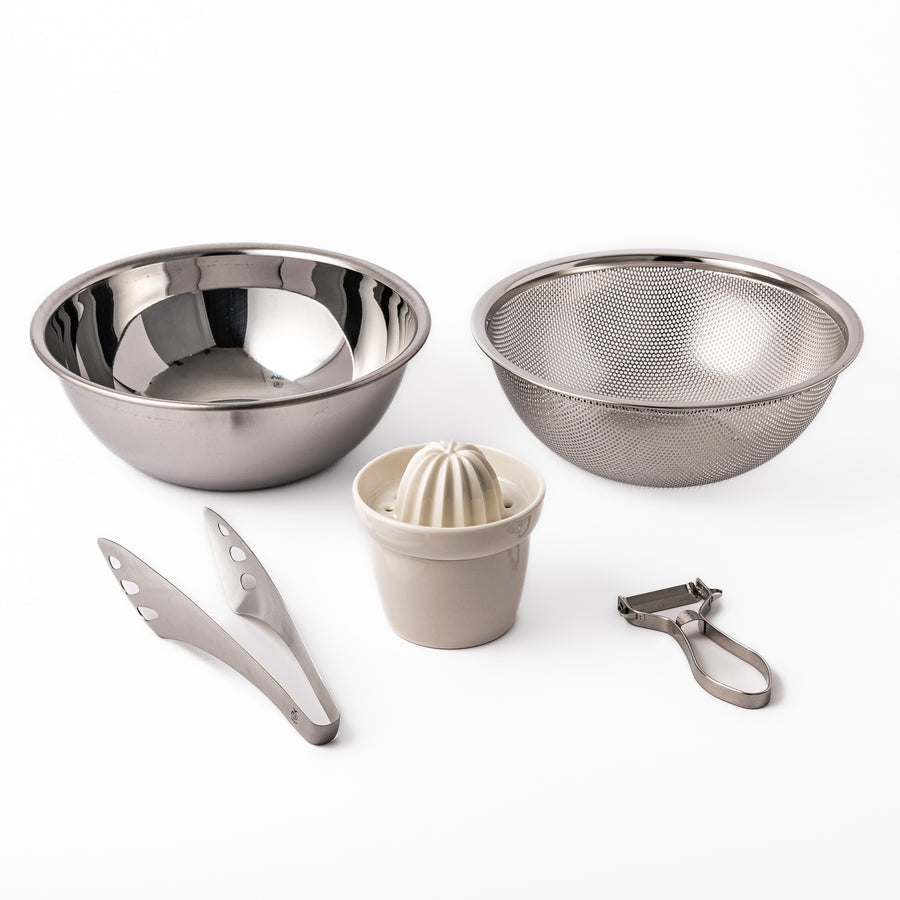 Japanese salad prep set featuring stainless steel mixing and strainer bowls, ceramic citrus juicer, peeler, and tongs, designed for effortless vegetable and dressing preparation.