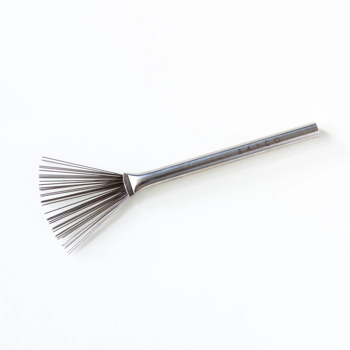 Japanese stainless steel grater brush displayed horizontally against a white background