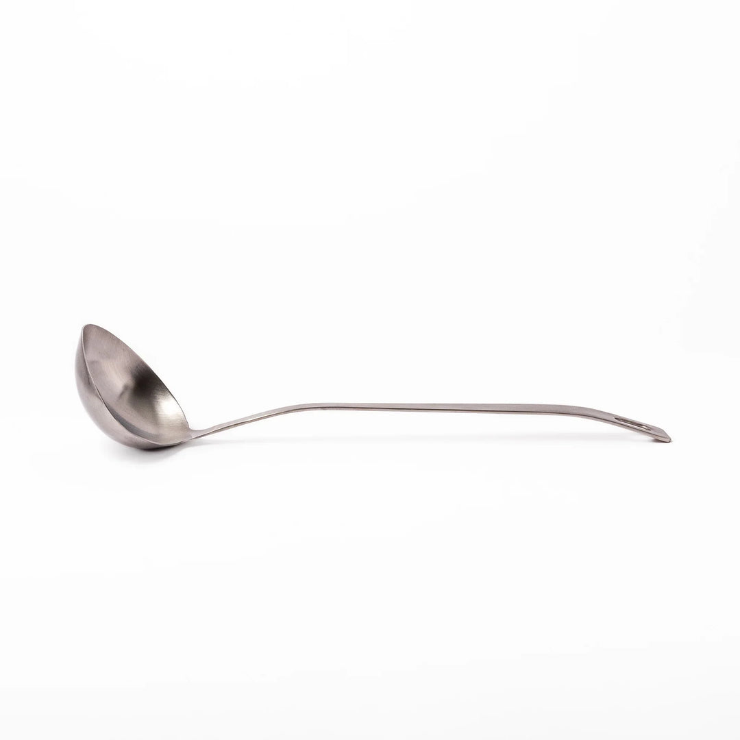 Japanese stainless steel soup ladle with long handle and deep curved bowl for serving soups and stews.
