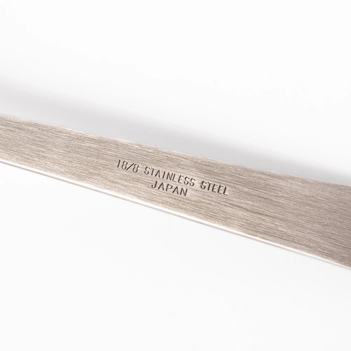 Japanese stainless steel soup ladle with long handle and deep curved bowl for serving soups and stews.