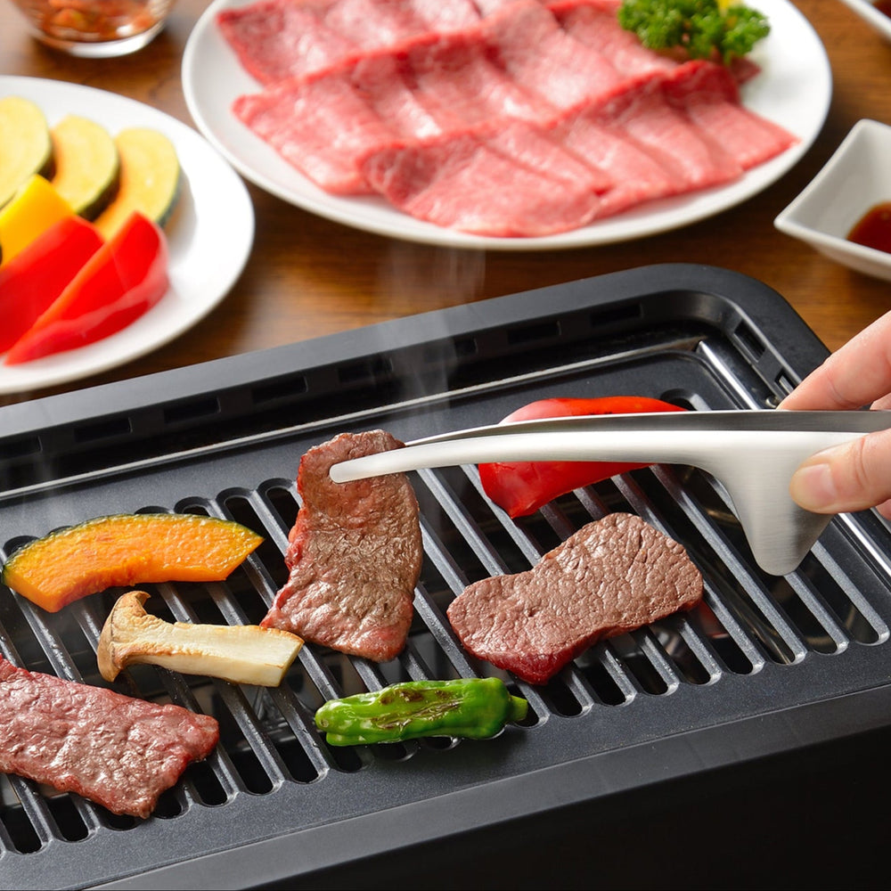 Grilling wagyu beef and vegetables on a tabletop BBQ with Japanese stainless steel tongs that keep the counter clean