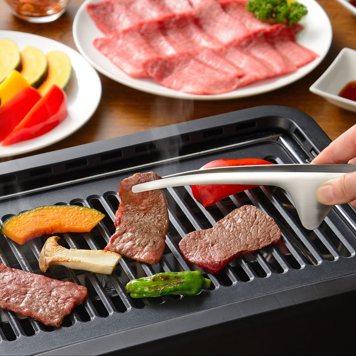 Grilling wagyu beef and vegetables on a tabletop BBQ with Japanese stainless steel tongs that keep the counter clean