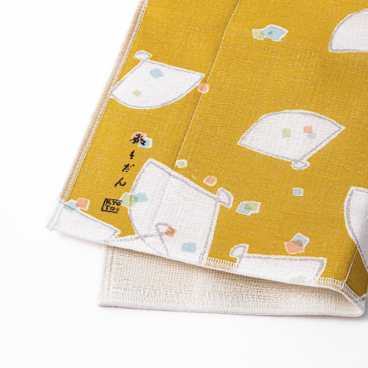 Kyoto Yuzen dyed Kaya cotton kitchen cloth featuring a mustard yellow background with colorful Japanese folding fan patterns