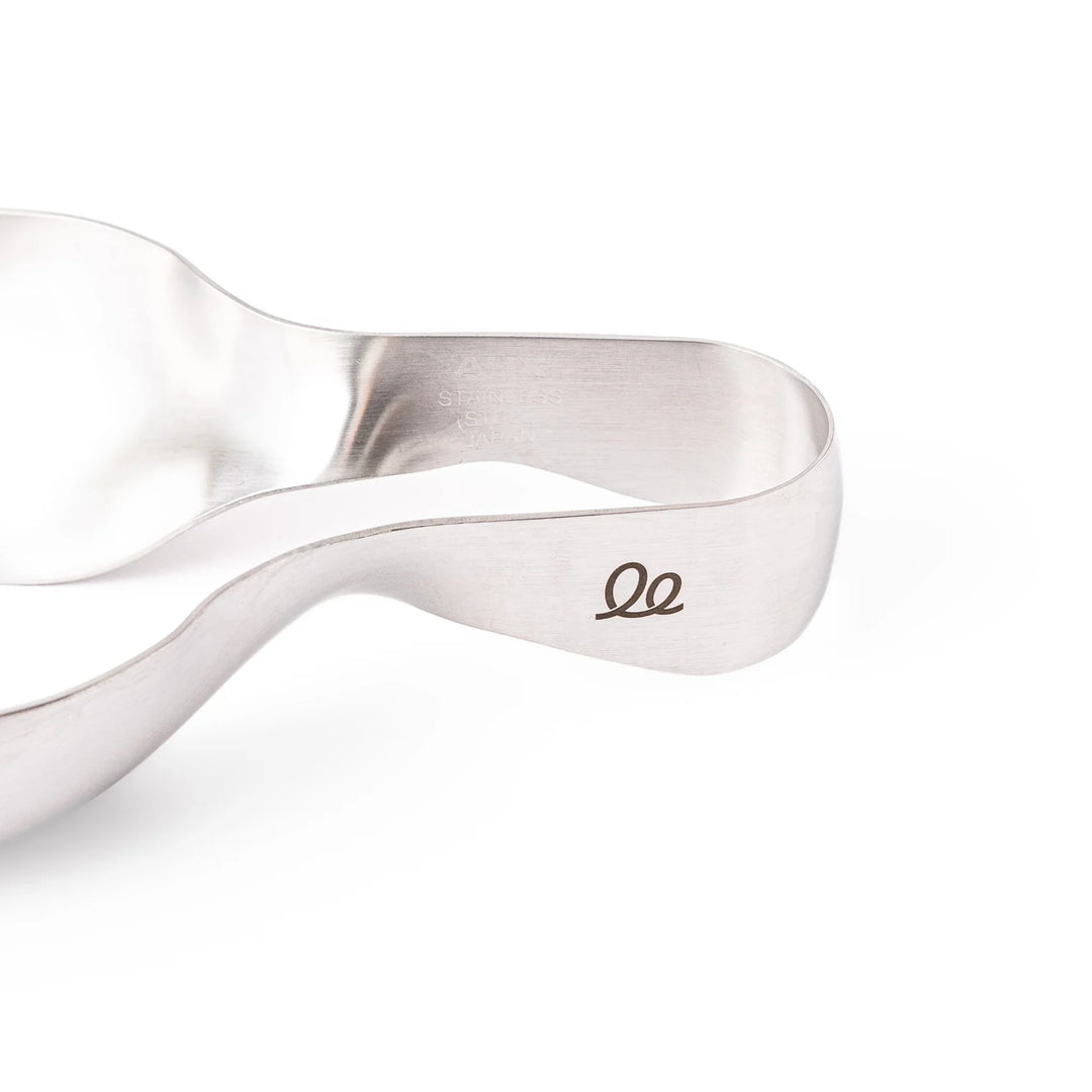 Japanese stainless steel ice scoop tongs with serrated edges and ergonomic curved design for secure grip and easy handling