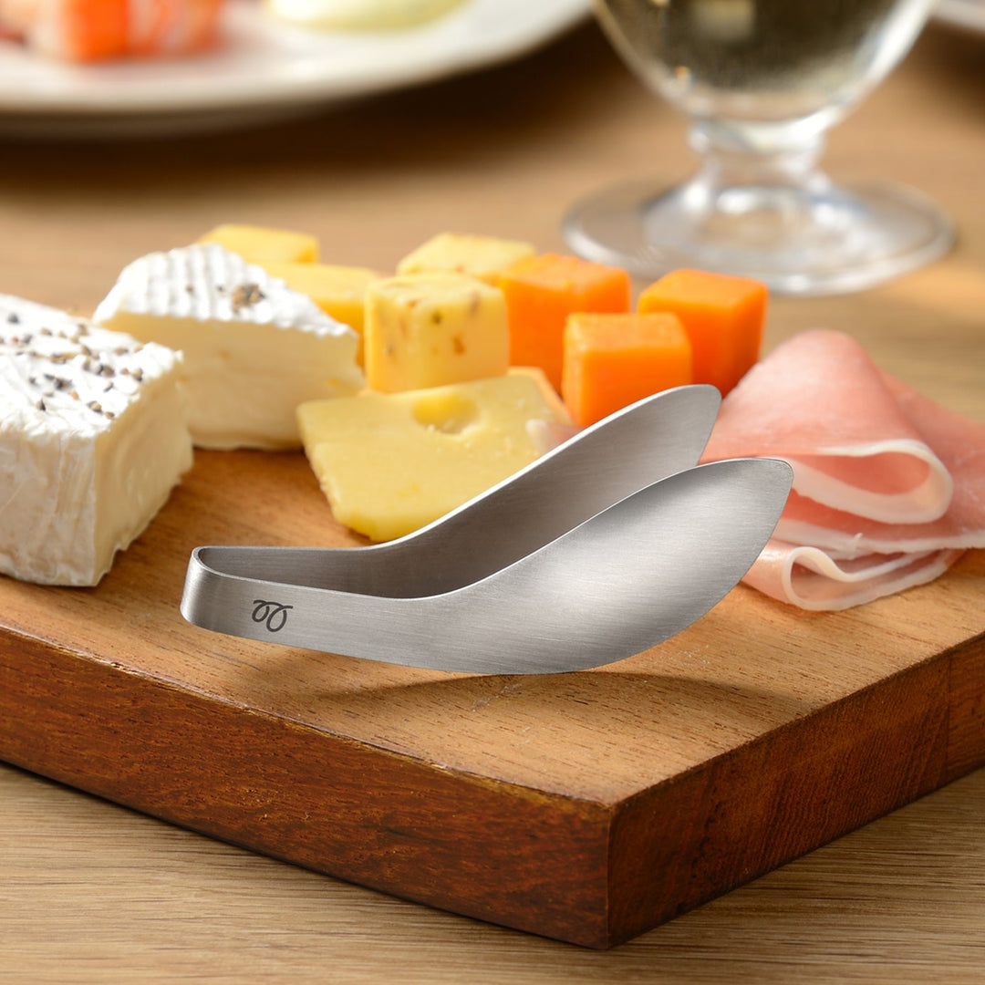 Mini stainless steel tongs with a unique curved design that keeps the tips elevated off the table for hygiene