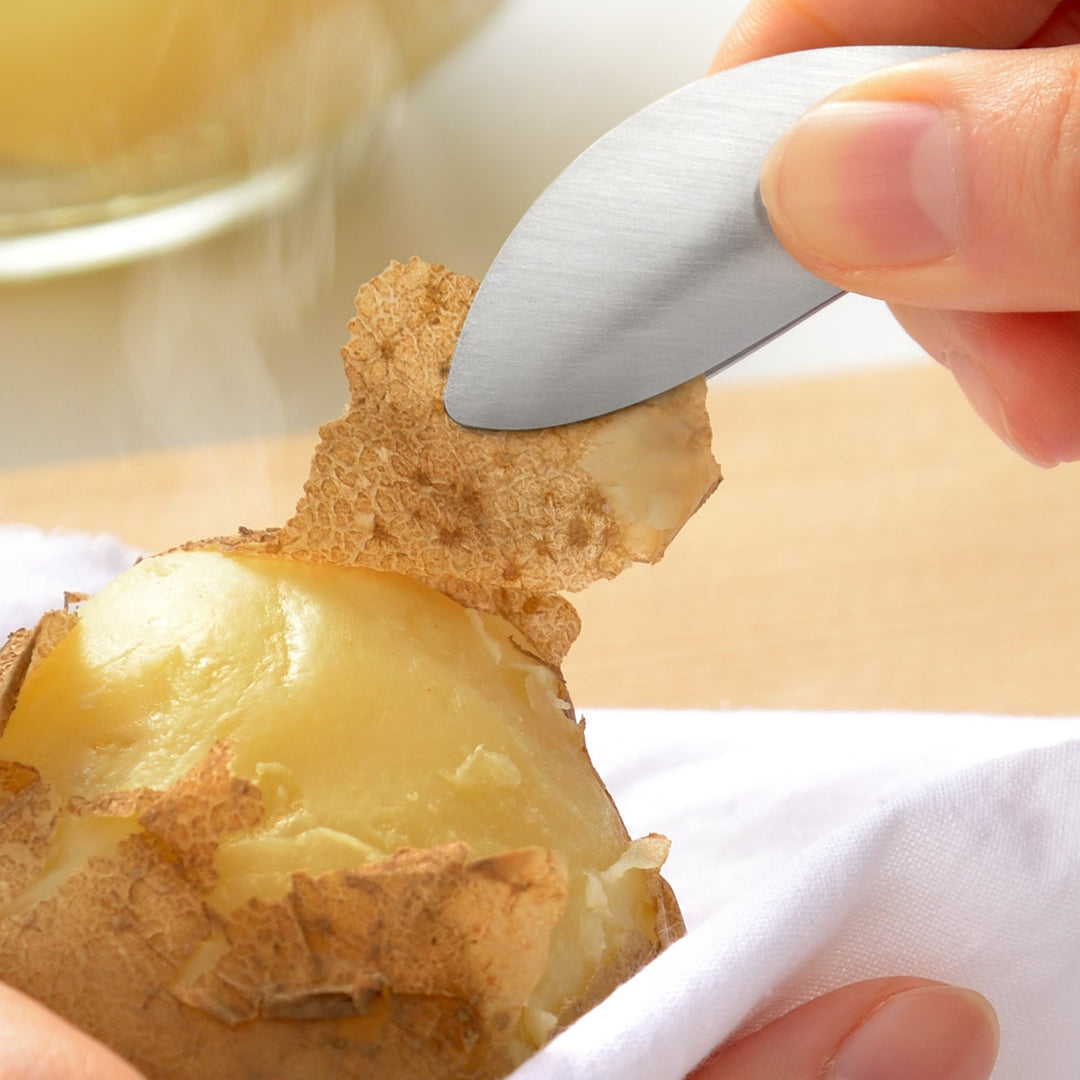 Japanese stainless steel fingertip tongs peeling the skin off a hot steamed potato to keep hands safe and clean