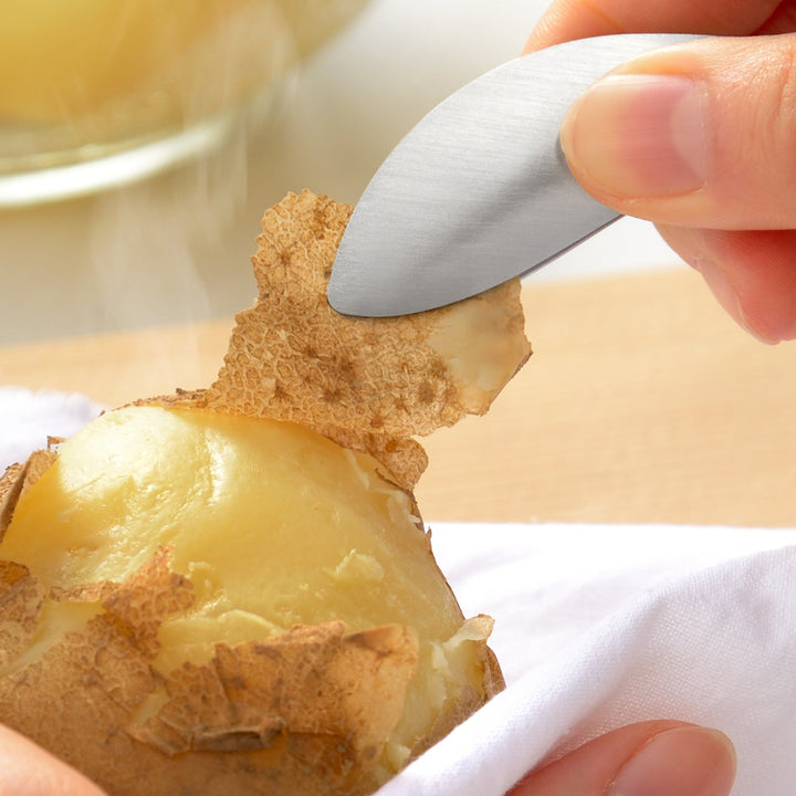 Japanese stainless steel fingertip tongs peeling the skin off a hot steamed potato to keep hands safe and clean