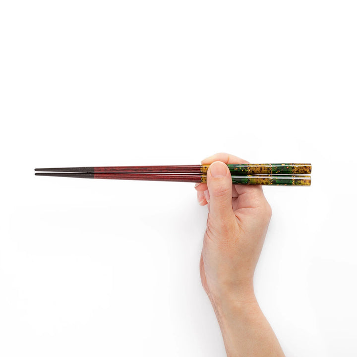 Japanese lacquer chopsticks shown held in hand