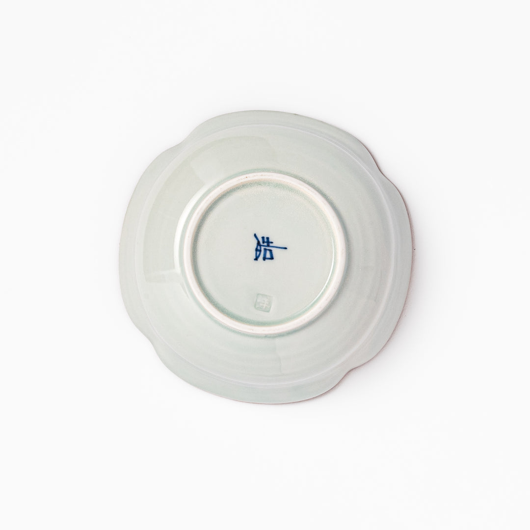 White ceramic cereal bowl with a scalloped rim, decorated inside with blue leaf motifs and a brown-accented edge.