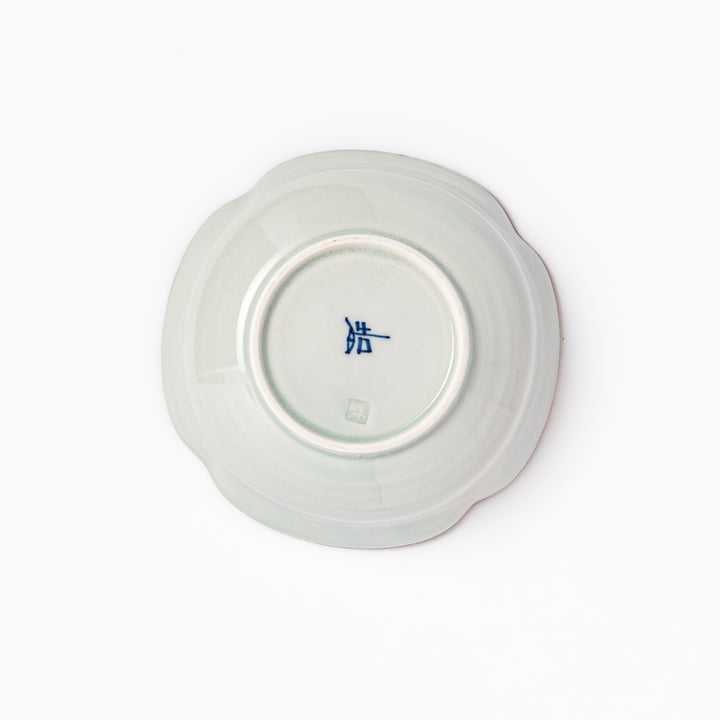 White ceramic cereal bowl with a scalloped rim, decorated inside with blue leaf motifs and a brown-accented edge.